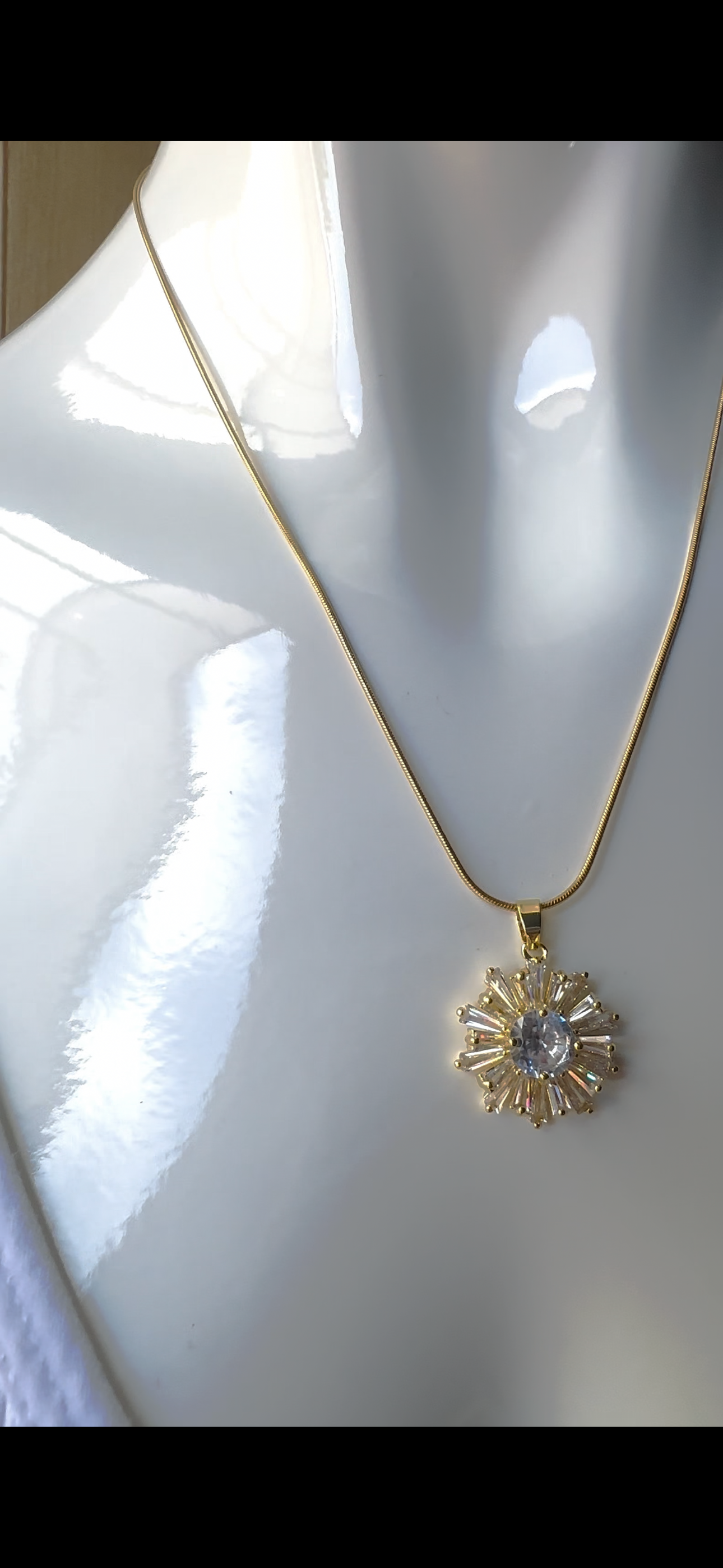 Stainless steel necklace with sunburst pendant