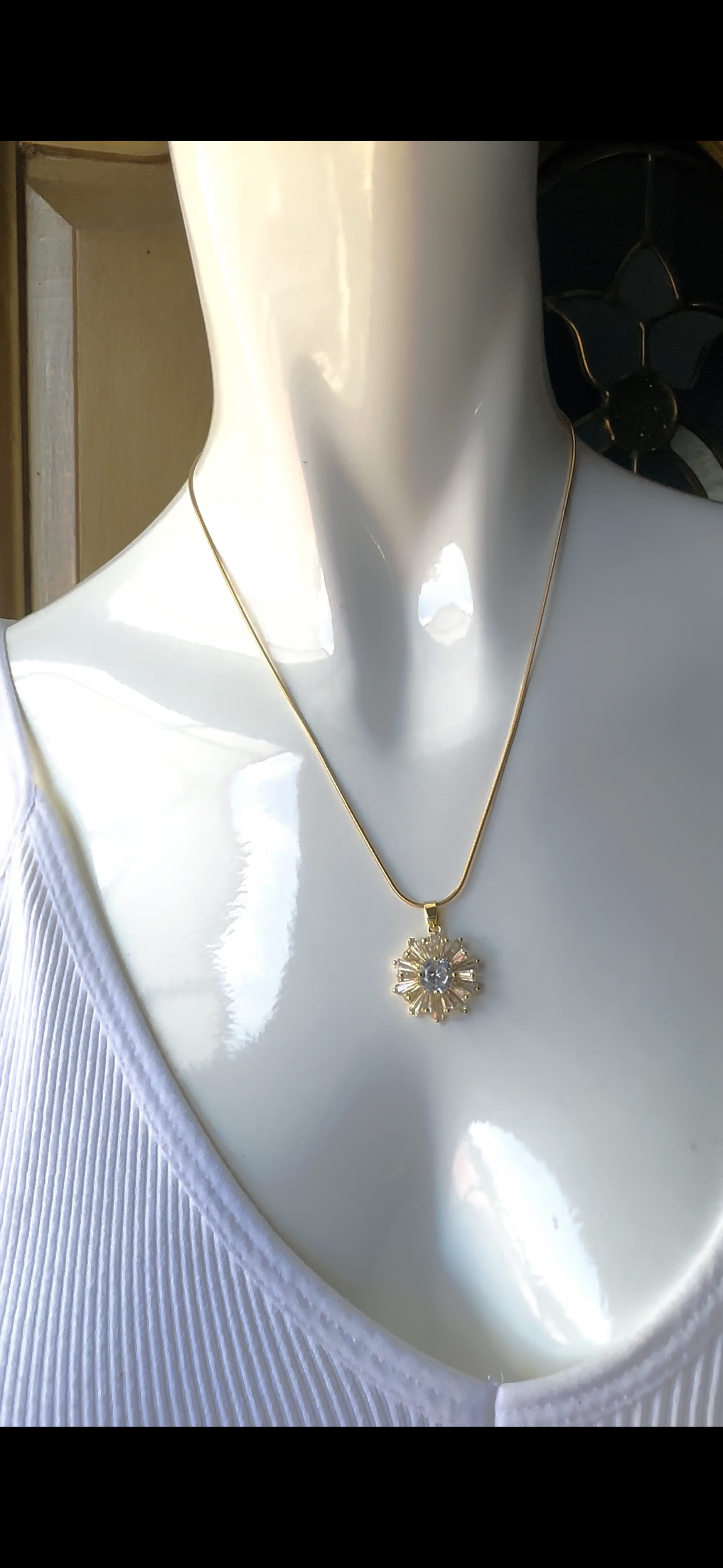 Stainless steel necklace with sunburst pendant