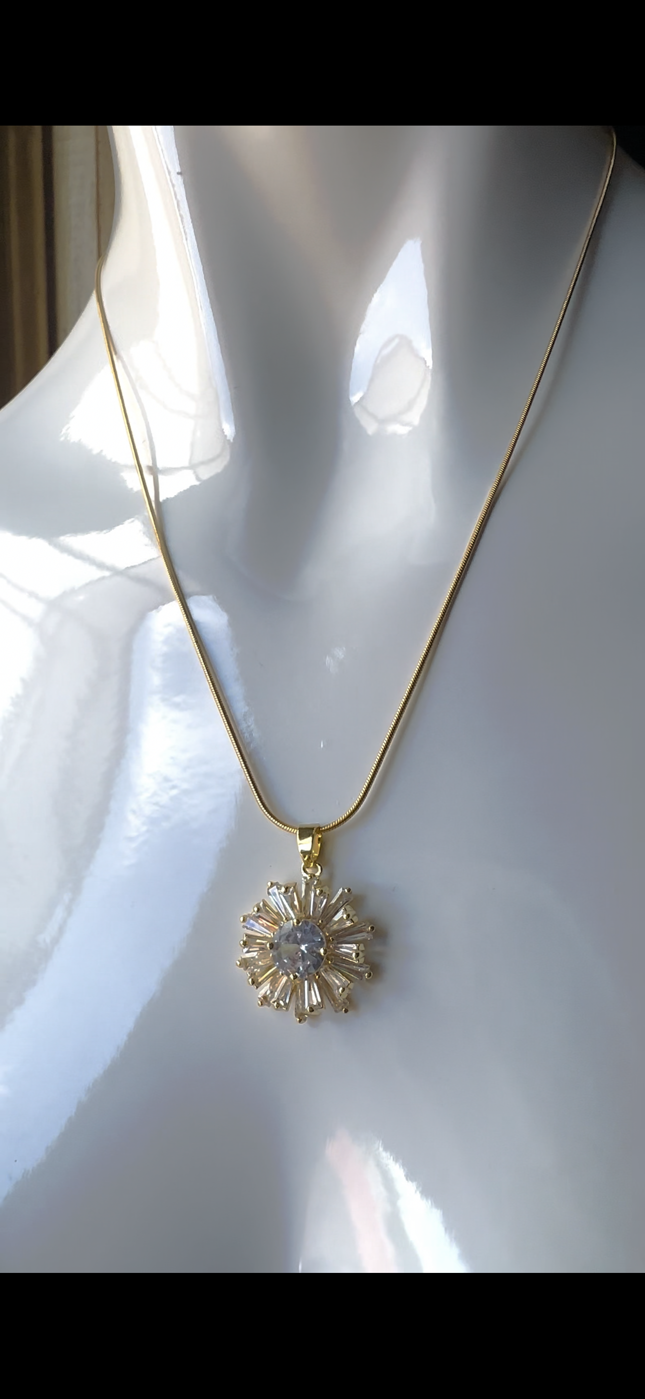 Stainless steel necklace with sunburst pendant